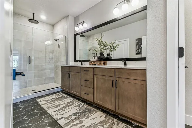 a bathroom with a double vanity sink and mirror