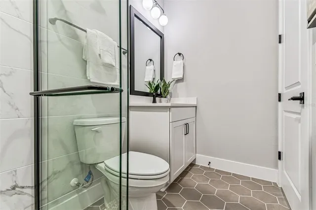 a white toilet sitting next to a bathroom sink