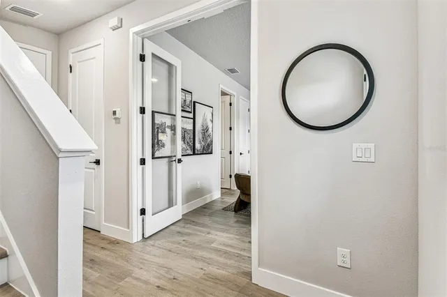 a living room with furniture potted plant and wooden floor