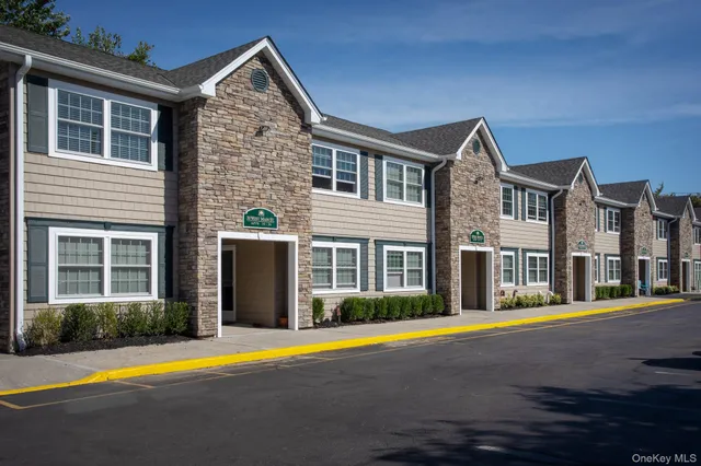 a front view of multiple houses with yard