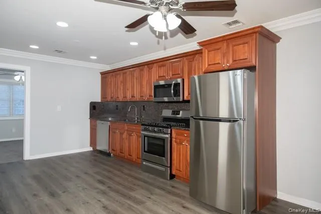 a kitchen with stainless steel appliances a refrigerator sink and microwave