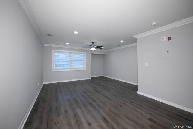 311 West Main Street, Unit 12 Patchogue, NY 11772 - Photo 4 of 8 an empty room with wooden floor and windows