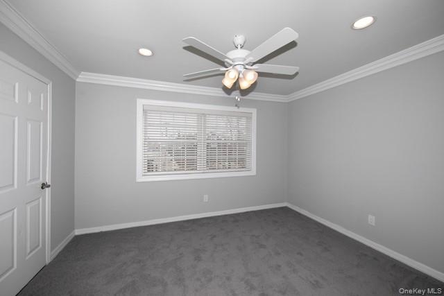 311 West Main Street, Unit 12 Patchogue, NY 11772 - Photo 6 of 8 an empty room with a window and ceiling fan