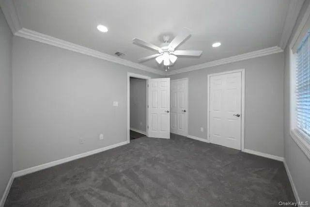 an empty room with a ceiling fan and a window
