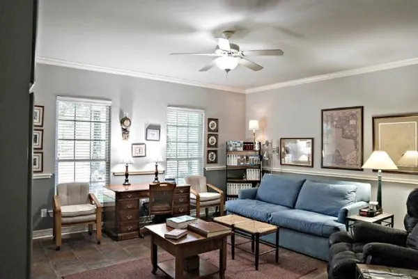 a living room with furniture and a large window or wooden floor