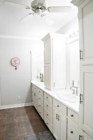 a spacious bathroom with a double vanity sink and a mirror