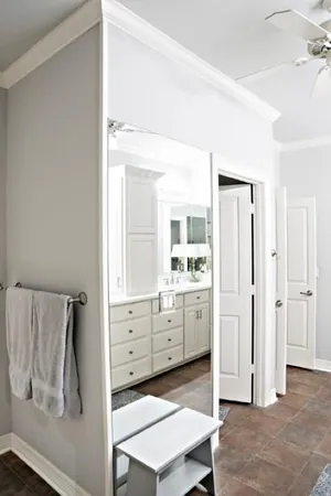 a room with white cabinets and window