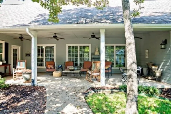 a view of a house with a yard and sitting area