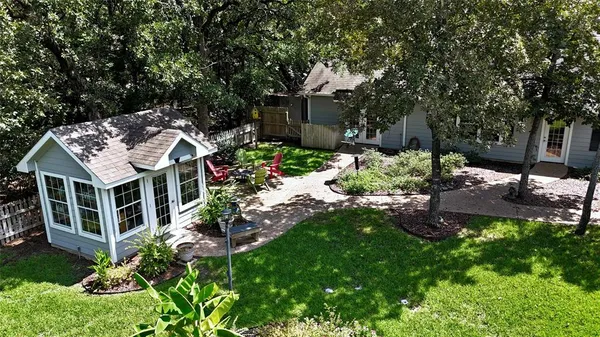 a view of a house with a yard and tree s