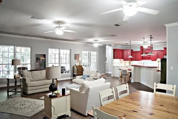 a living room with lots of furniture and kitchen view