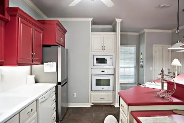 a kitchen with stainless steel appliances kitchen island granite countertop a refrigerator and microwave