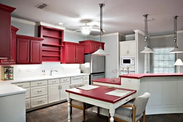 a kitchen with stainless steel appliances kitchen island granite countertop a table chairs and a wooden cabinets