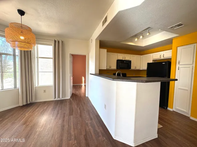 a view of kitchen with furniture wooden floor and window