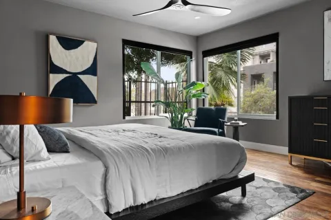 a bedroom with a bed and a large window