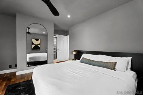 a bedroom with a bed and a large window