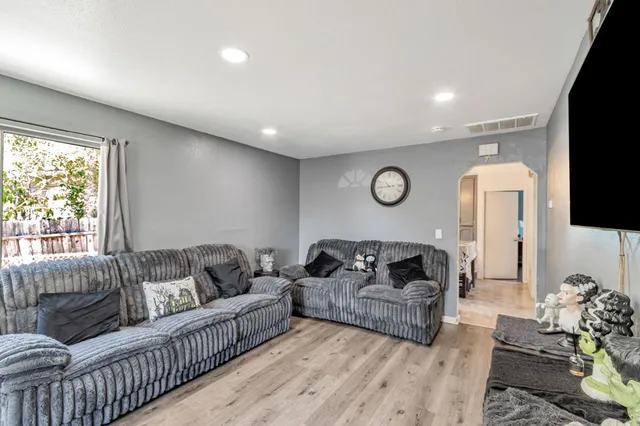 a living room with furniture a couch and a flat screen tv
