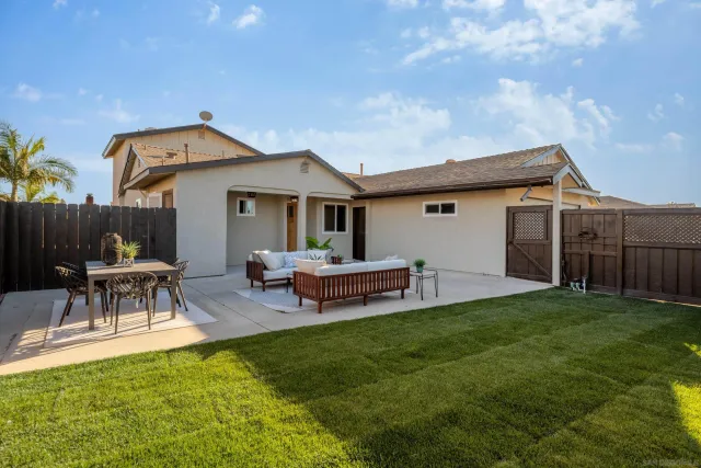 a view of a house with a backyard and a patio