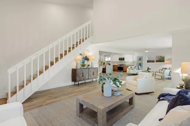 a living room with furniture and a dining table