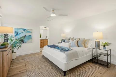 a bedroom with a bed and a potted plant