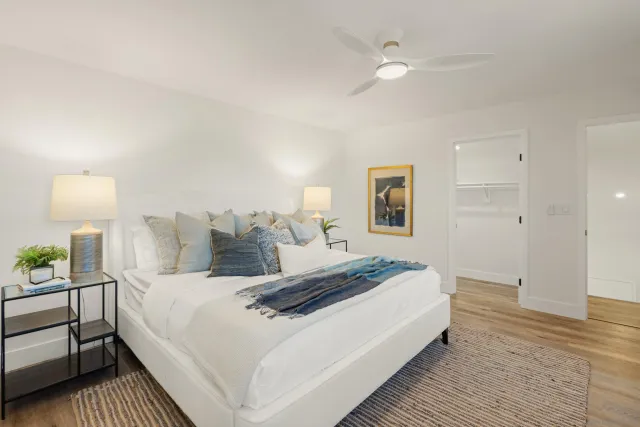 a bedroom with a bed and a lamp