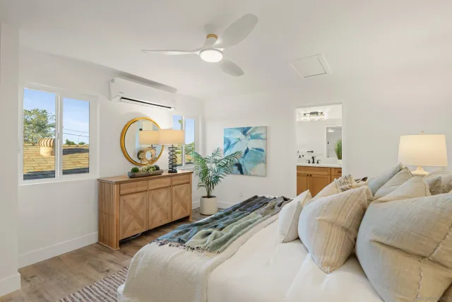 a bed room with a bed mirror and a window