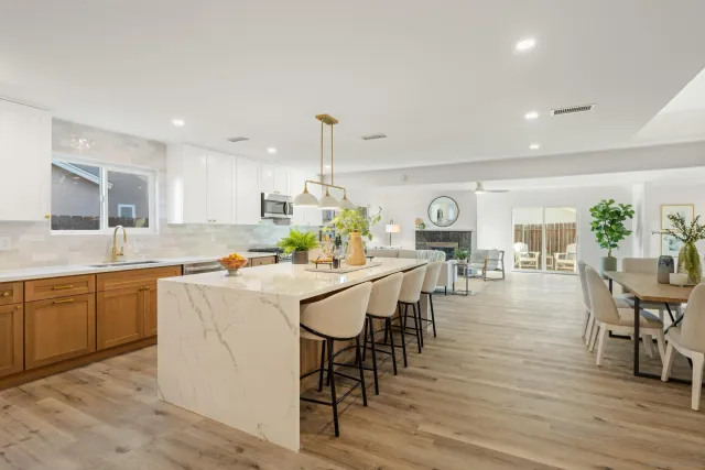 a large kitchen with a table and chairs