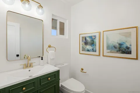 a bathroom with a toilet a sink and mirror
