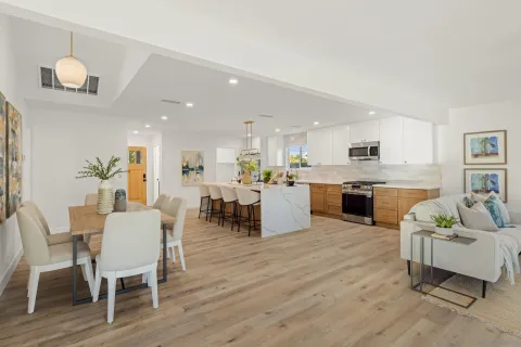 a living room with furniture and kitchen view