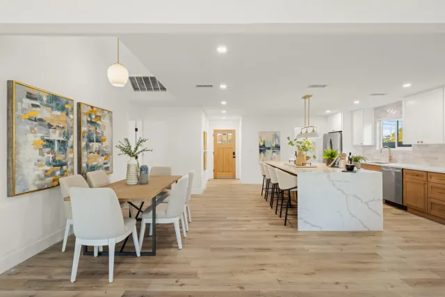 a view of a dining room with furniture and wooden floor