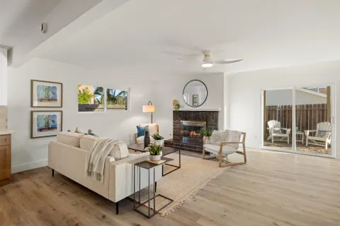 a living room with furniture a fireplace and a table