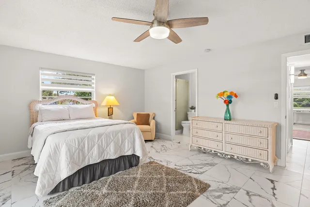 a bathroom with a sink mirror and a toilet