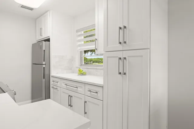 a kitchen with stainless steel appliances a stove a microwave and sink