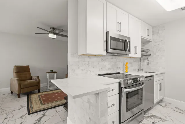 a kitchen with a sink stove and cabinets
