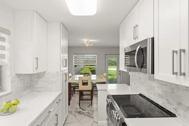 a view of a dining room with furniture and a chandelier