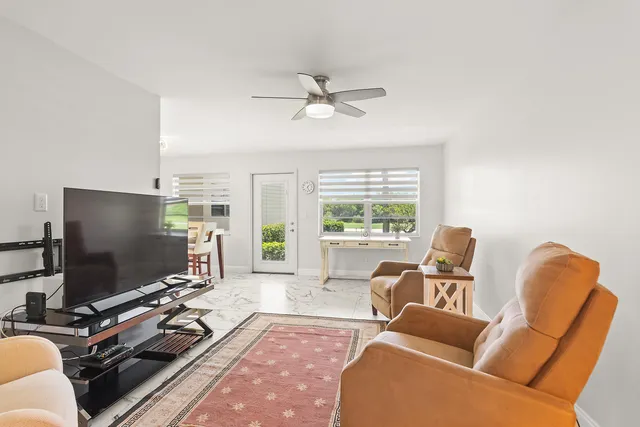 a bedroom with a bed and a flat tv screen on dresser
