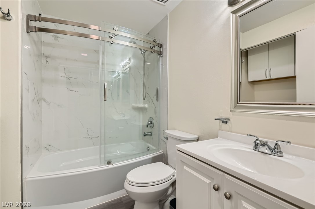 3665 Bronco Road Las Vegas, NV 89103 - Photo 19 of 28 Refined bathroom with a pristine tub-shower combo and a classic vanity.