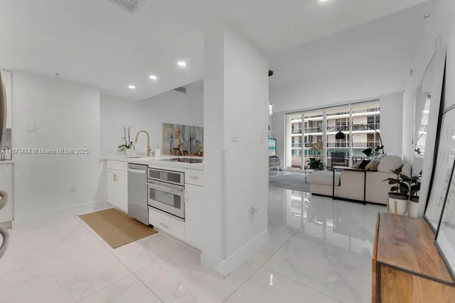 a kitchen with stainless steel appliances a stove a sink and a refrigerator