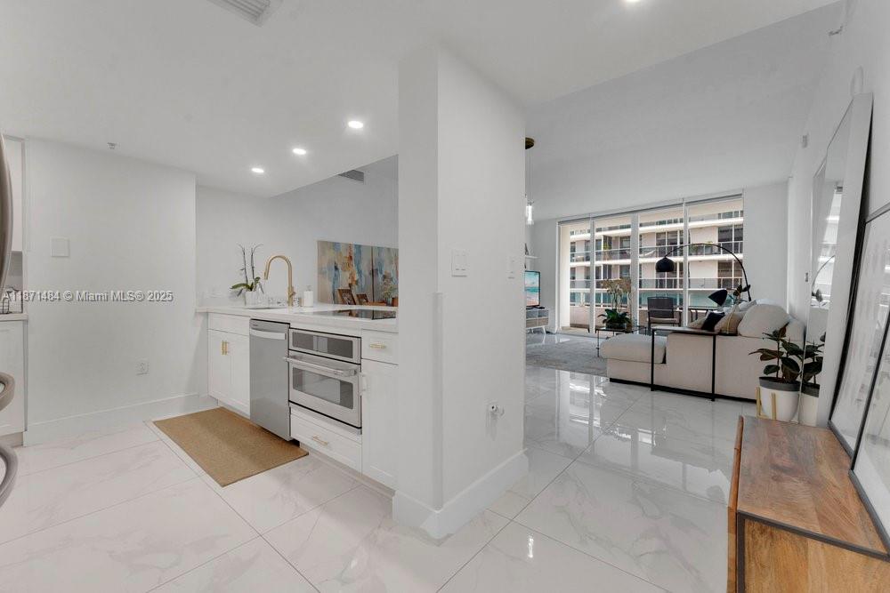 a kitchen with stainless steel appliances a stove a sink and a refrigerator