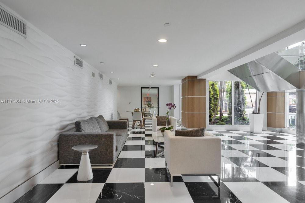1800 North Bayshore Drive, Unit 614 Miami, FL 33132 - Photo 19 of 29 a living room with couches and a potted plant on a coffee table with outer view