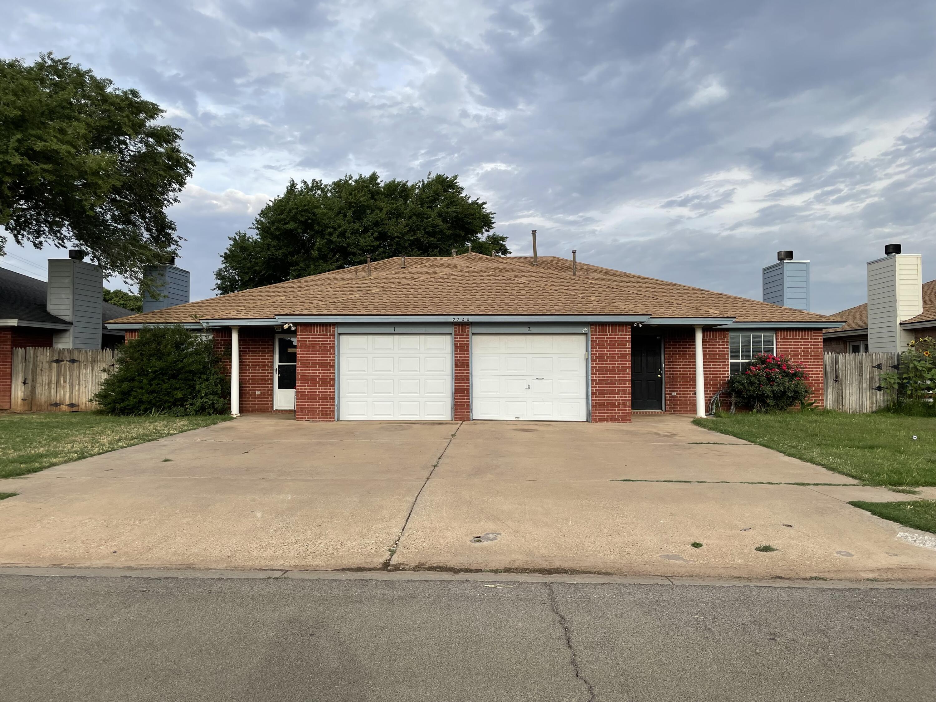 2344 78th Street Lubbock, TX 79423 - Photo 1 of 13 front view of house with a yard