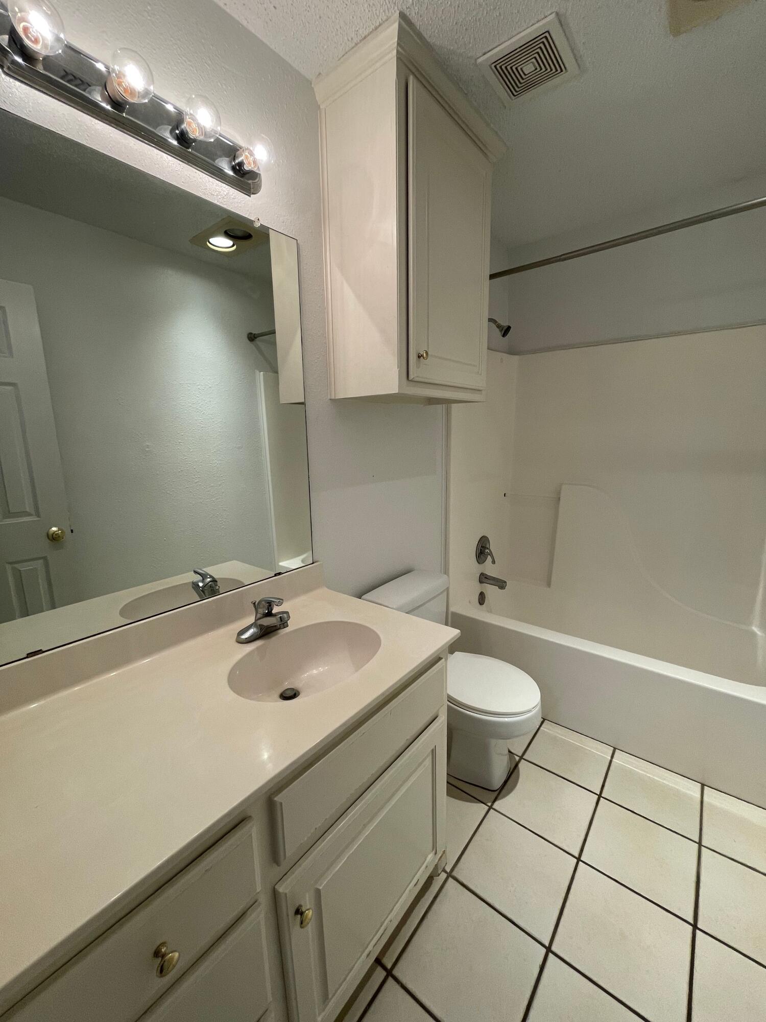 2344 78th Street Lubbock, TX 79423 - Photo 8 of 13 a bathroom with a sink a toilet and shower