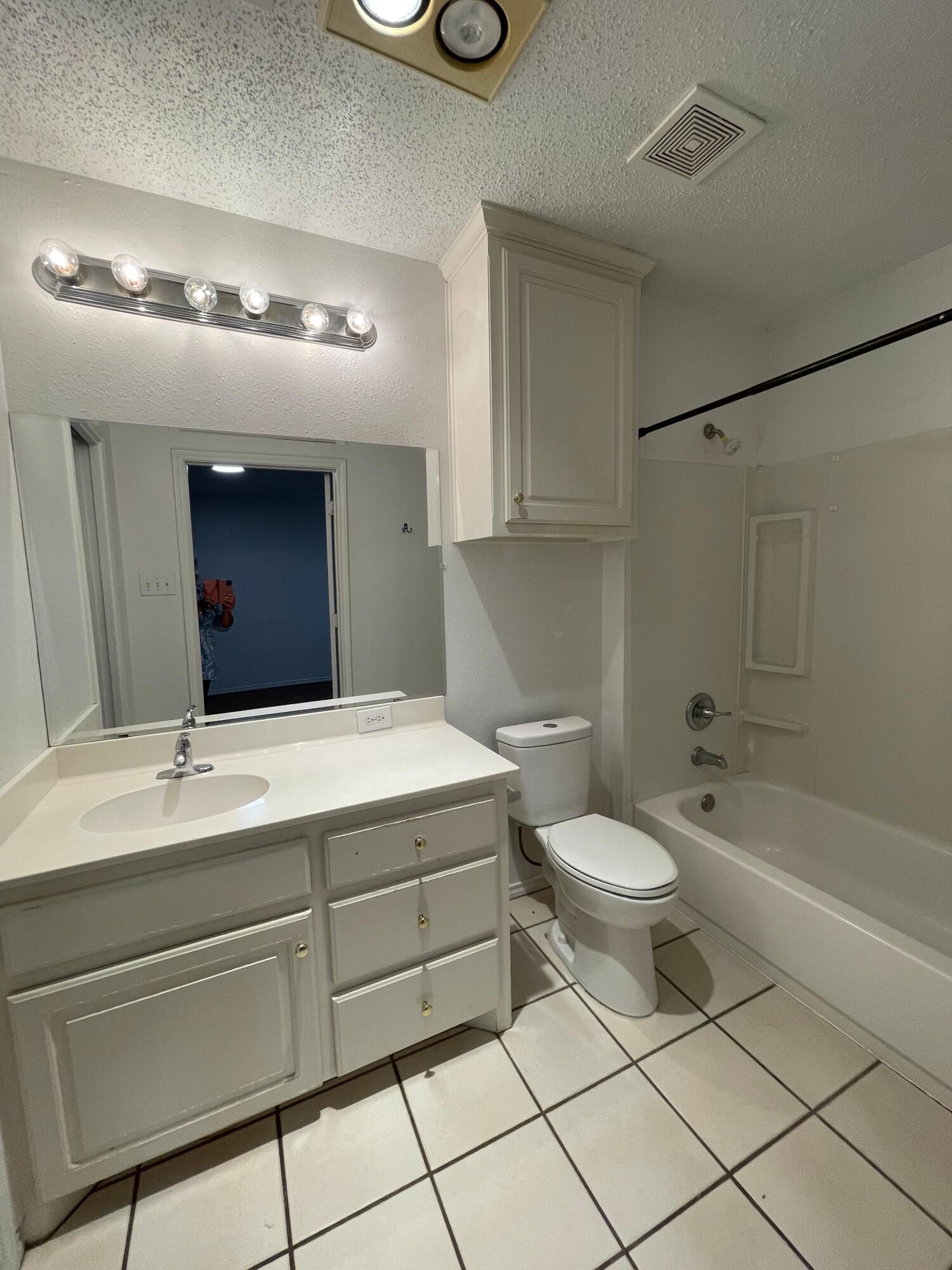 2344 78th Street Lubbock, TX 79423 - Photo 10 of 13 a bathroom with a toilet sink and mirror