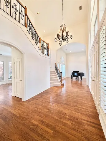 a view of a room with wooden floor and stairs