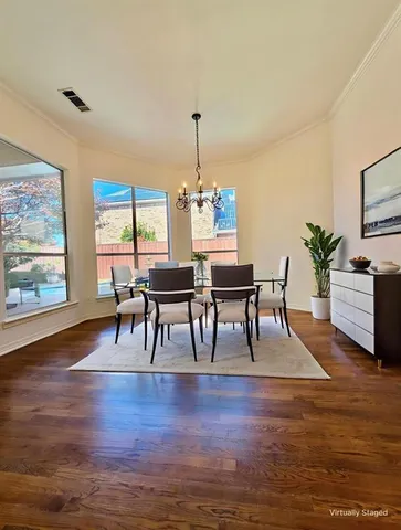 a dining room with furniture windows and wooden floor