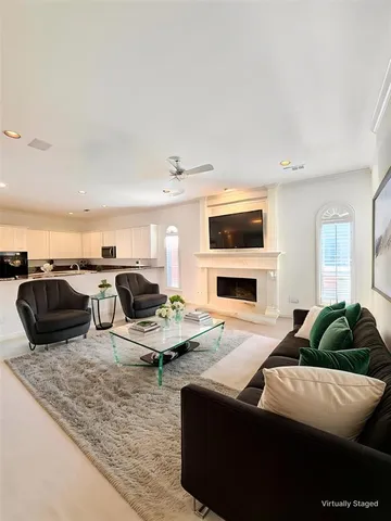 a living room with furniture flat screen tv and a fireplace