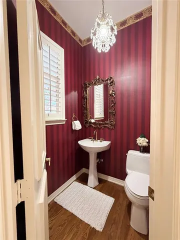 a bathroom with a sink a toilet and mirror