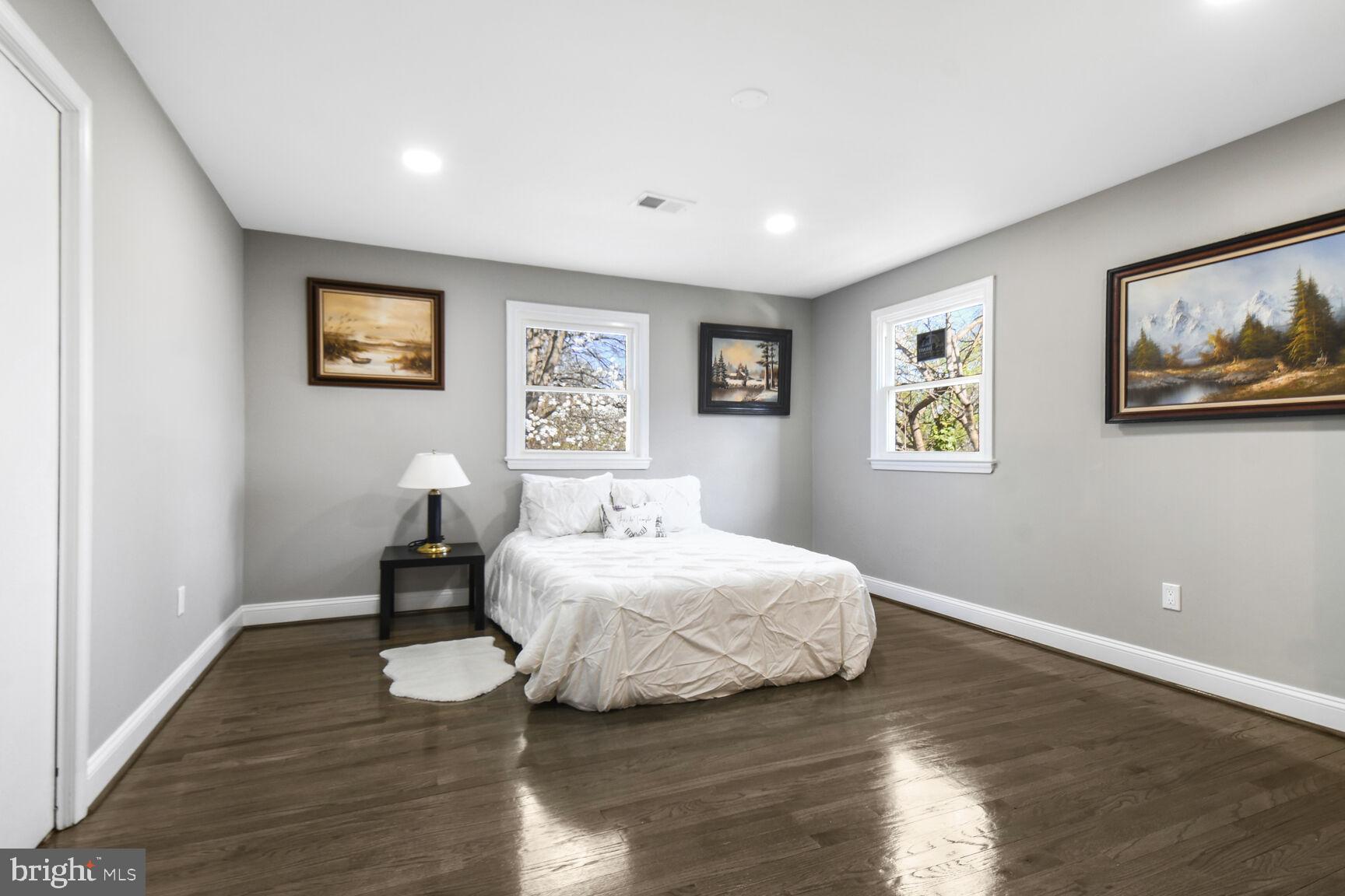 8730 Edmonston Road College Park, MD 20740 - Photo 8 of 15 a bedroom with a bed and a painting on the wall