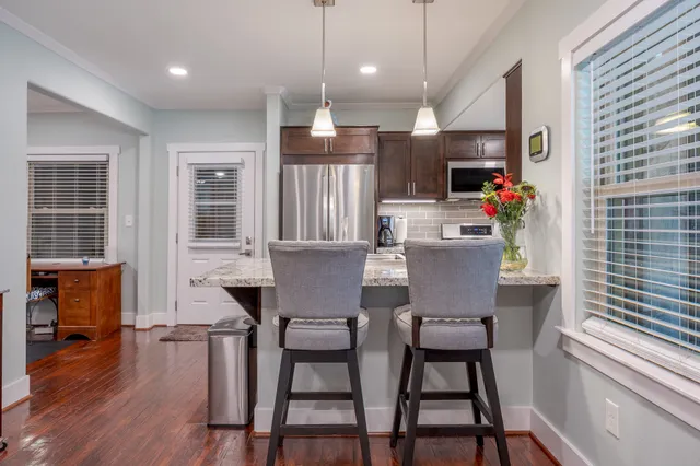 a kitchen with granite countertop a stove and refrigerator