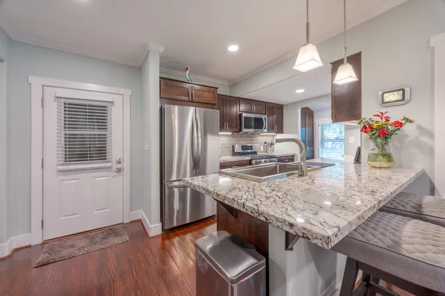 a kitchen with stainless steel appliances granite countertop counter space a sink and stove