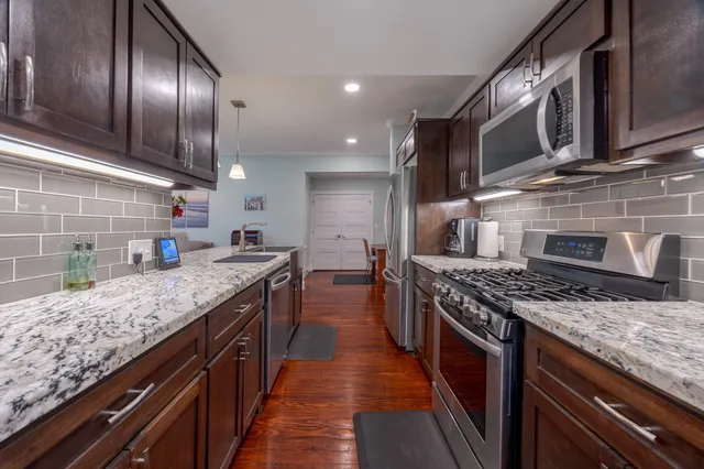 a kitchen with a stove and a refrigerator